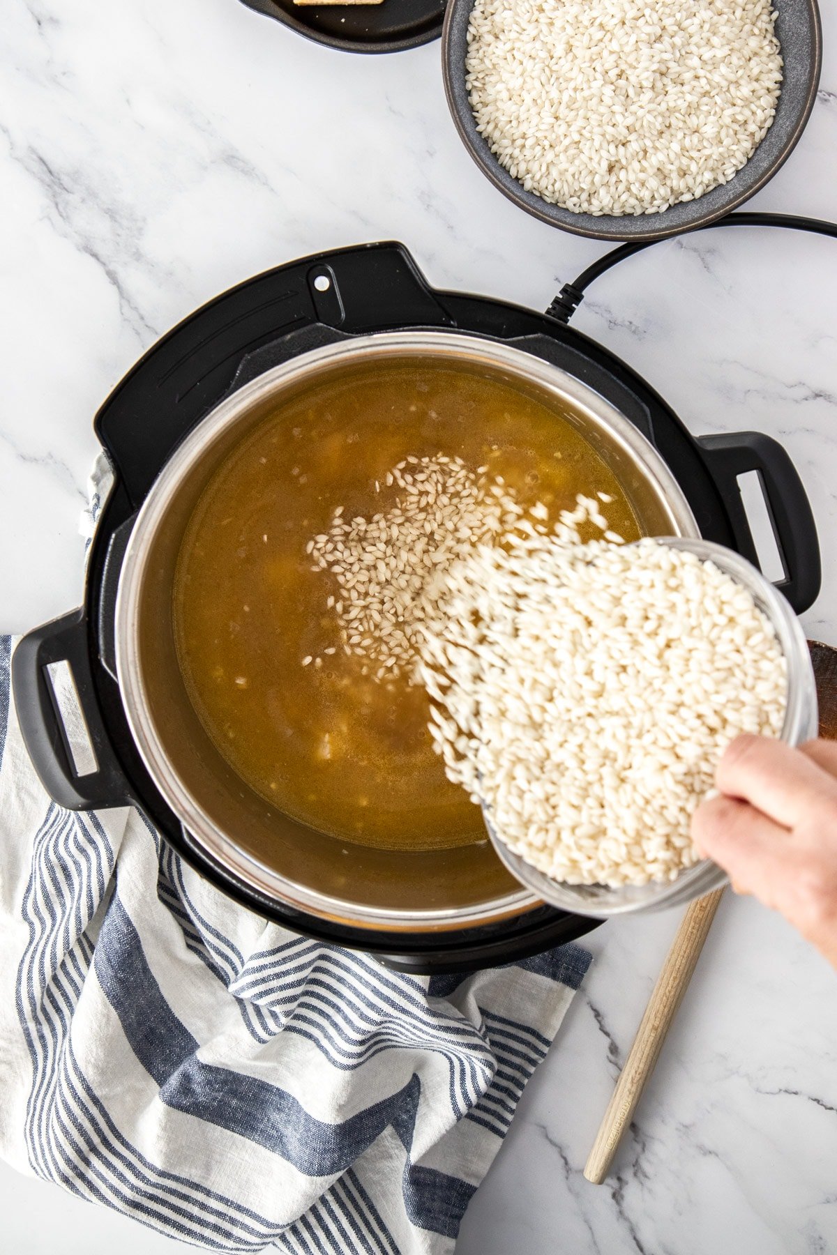 rice being poured into a pressure cooker.