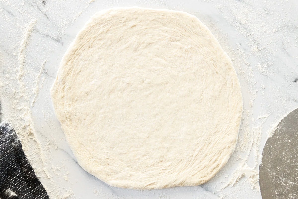 unbaked dough on a marbled board.