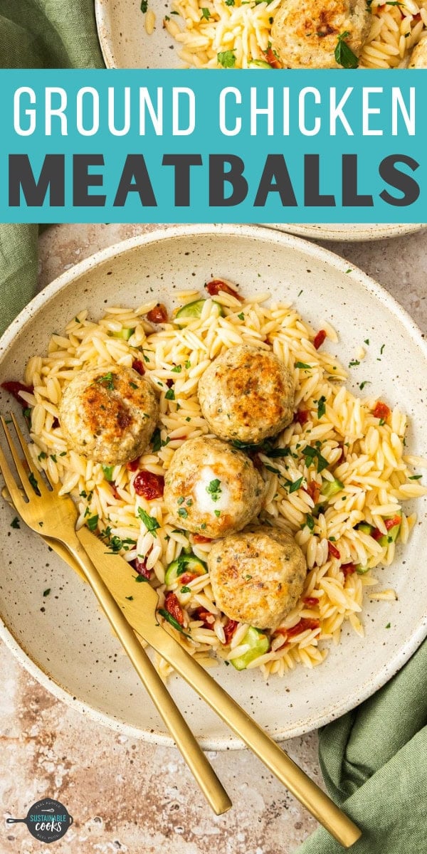 chicken meatballs topping a plate of orzo pasta with herbs.