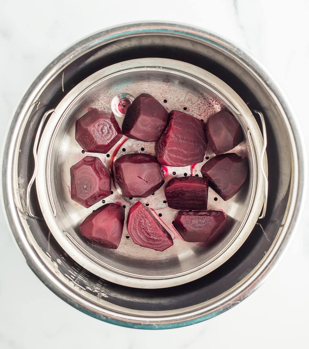 cooked beets in a steamer basket.