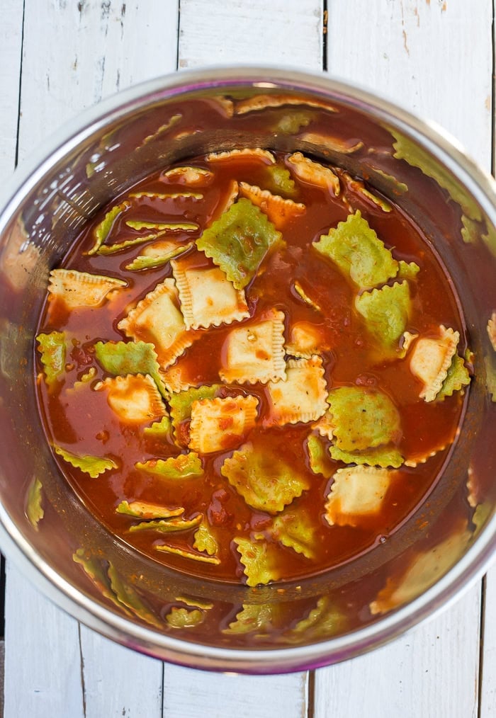 colorful pasta mixed with marinara.