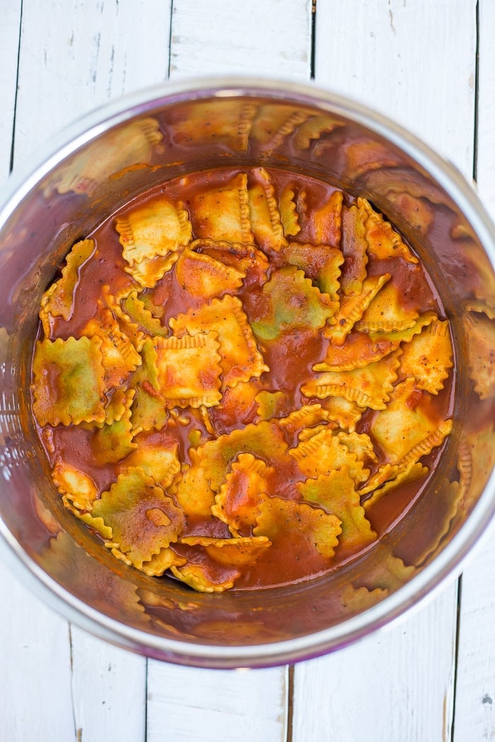 cooked ravioli with marinara sauce in an Instant Pot insert.