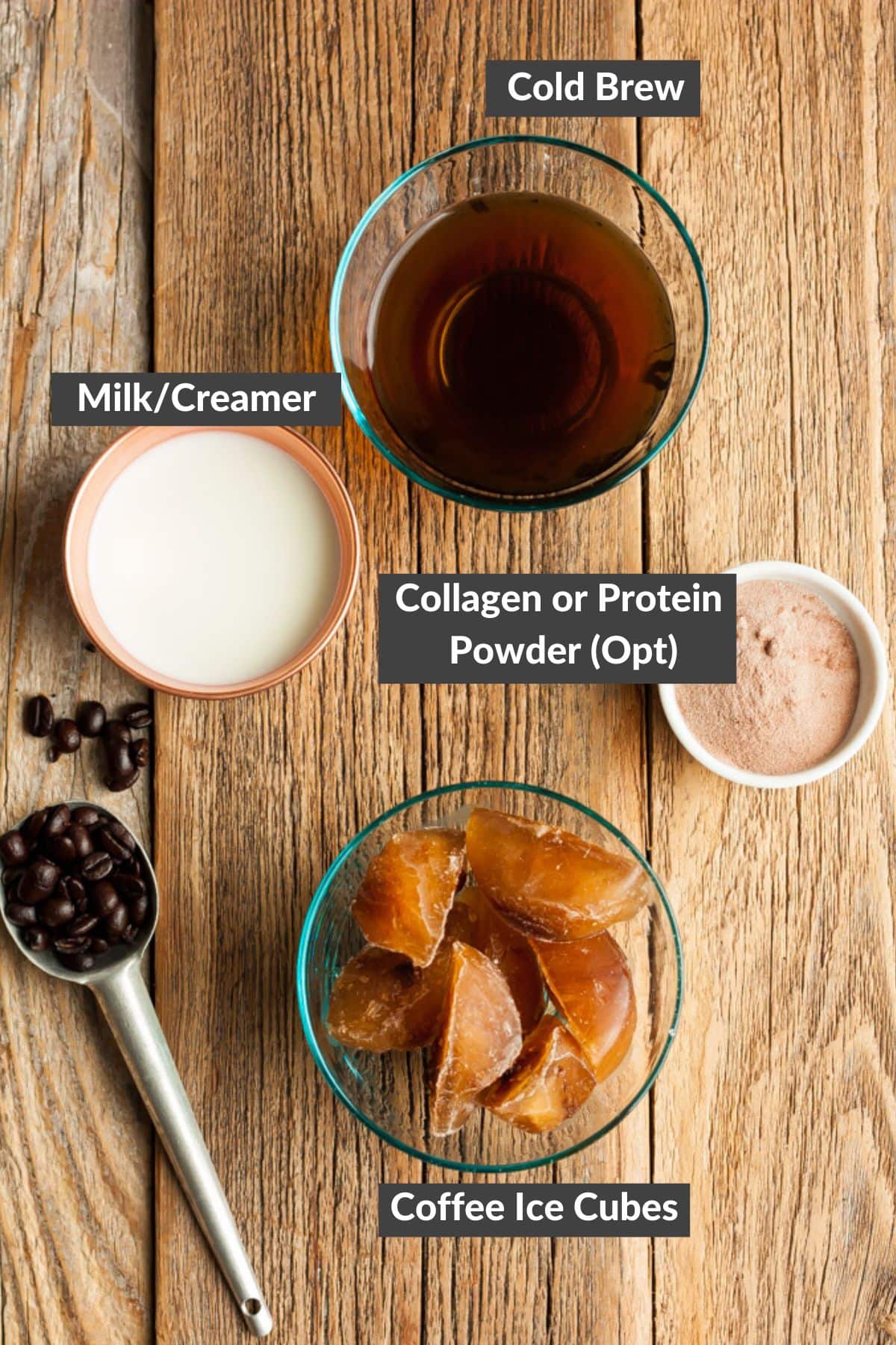 cold brew, coffee ice cubes, and creamer on a wooden board.