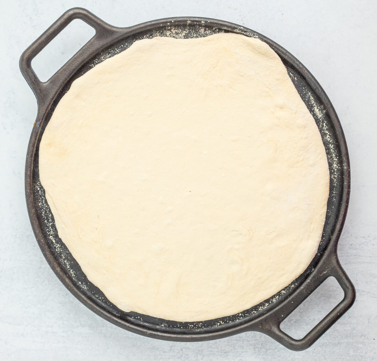 dough on a pizza pan.