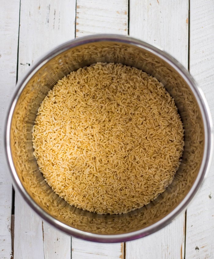 cooked rice and water in a pressure cooker insert.