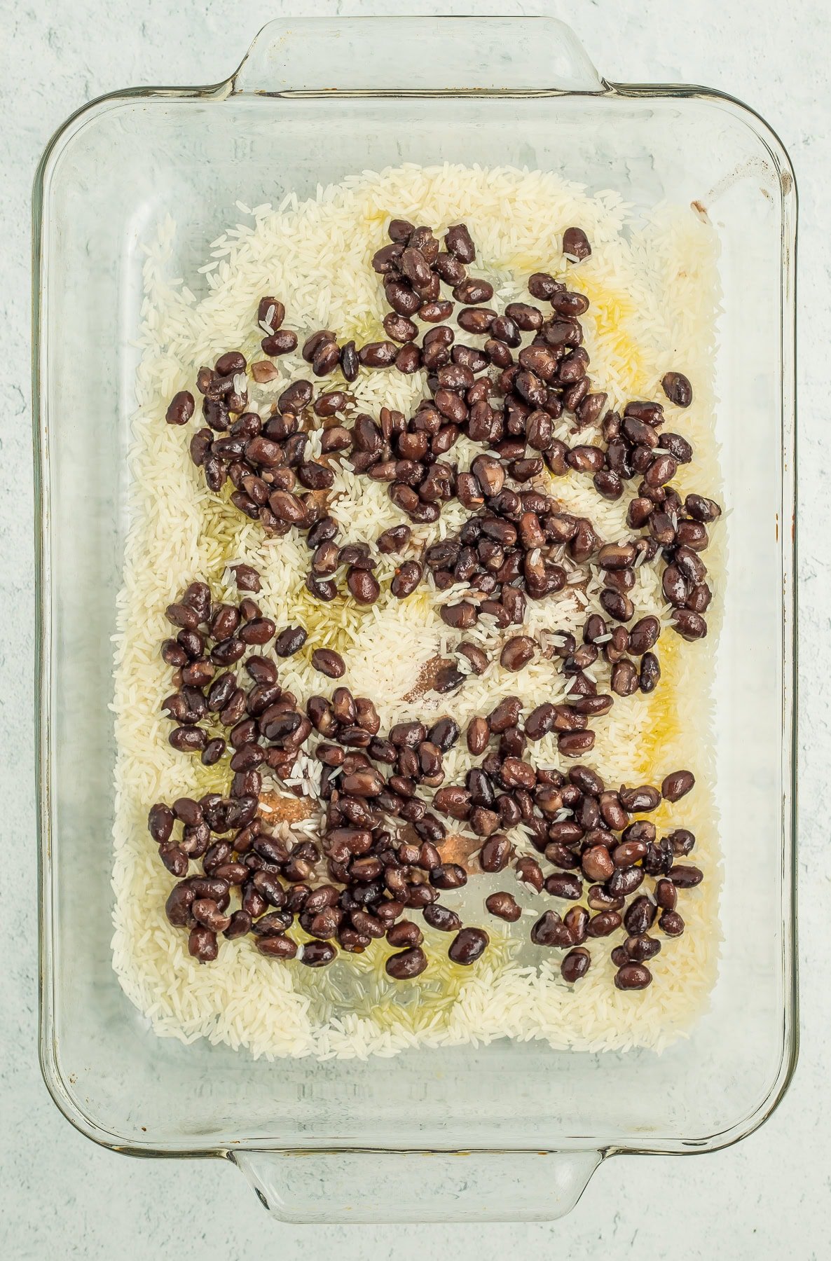 a baking dish with rice and black beans.