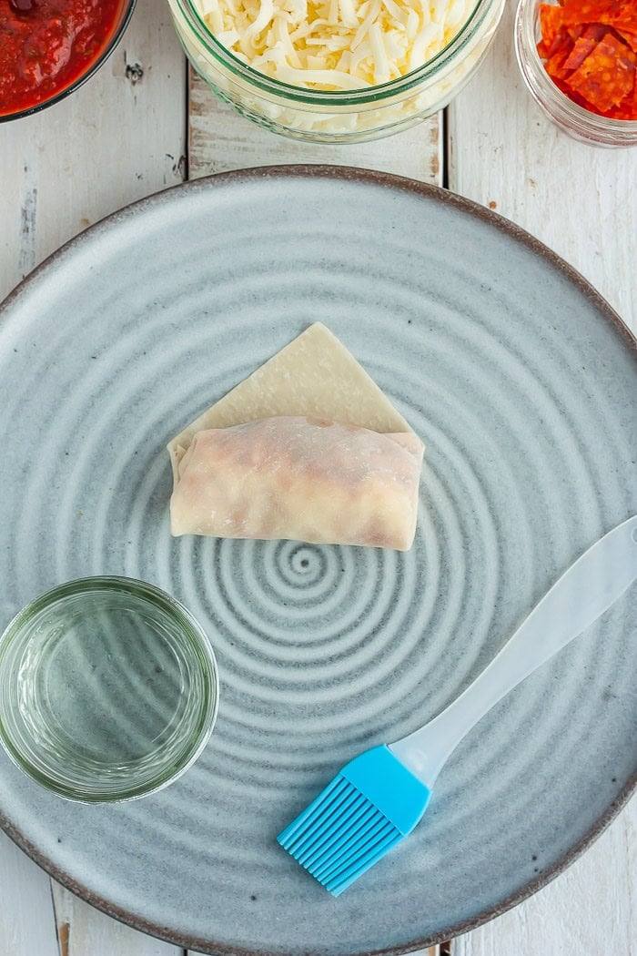 a photo showing step 7 in how to fold a won ton wrapper.