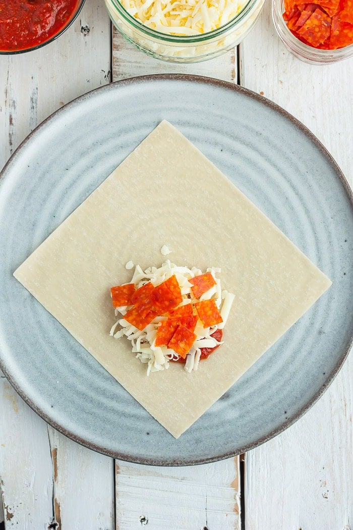 a photo showing step 3 in how to fold a won ton wrapper.