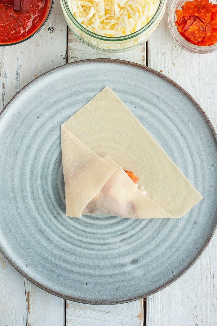 a photo showing step 5 in how to fold a won ton wrapper.