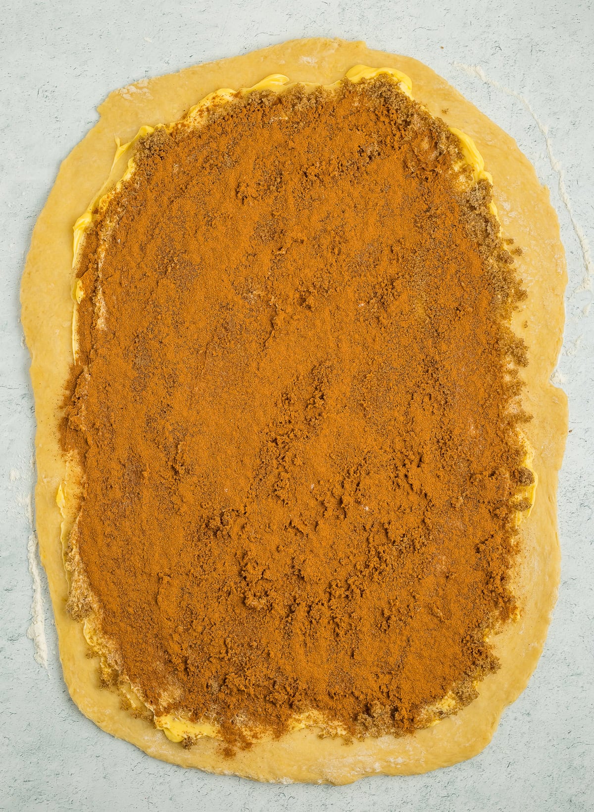 ingredients spread over unbaked rolled out dough.