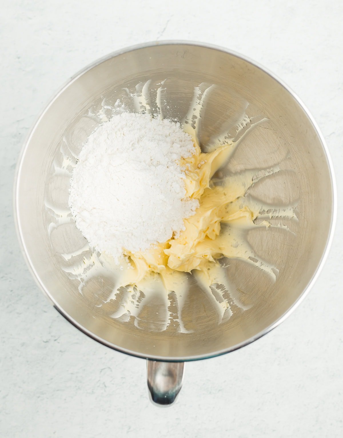powdered sugar and ingredients in a mixing bowl.
