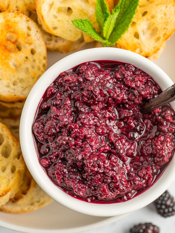 a white bowl of berry sauce.