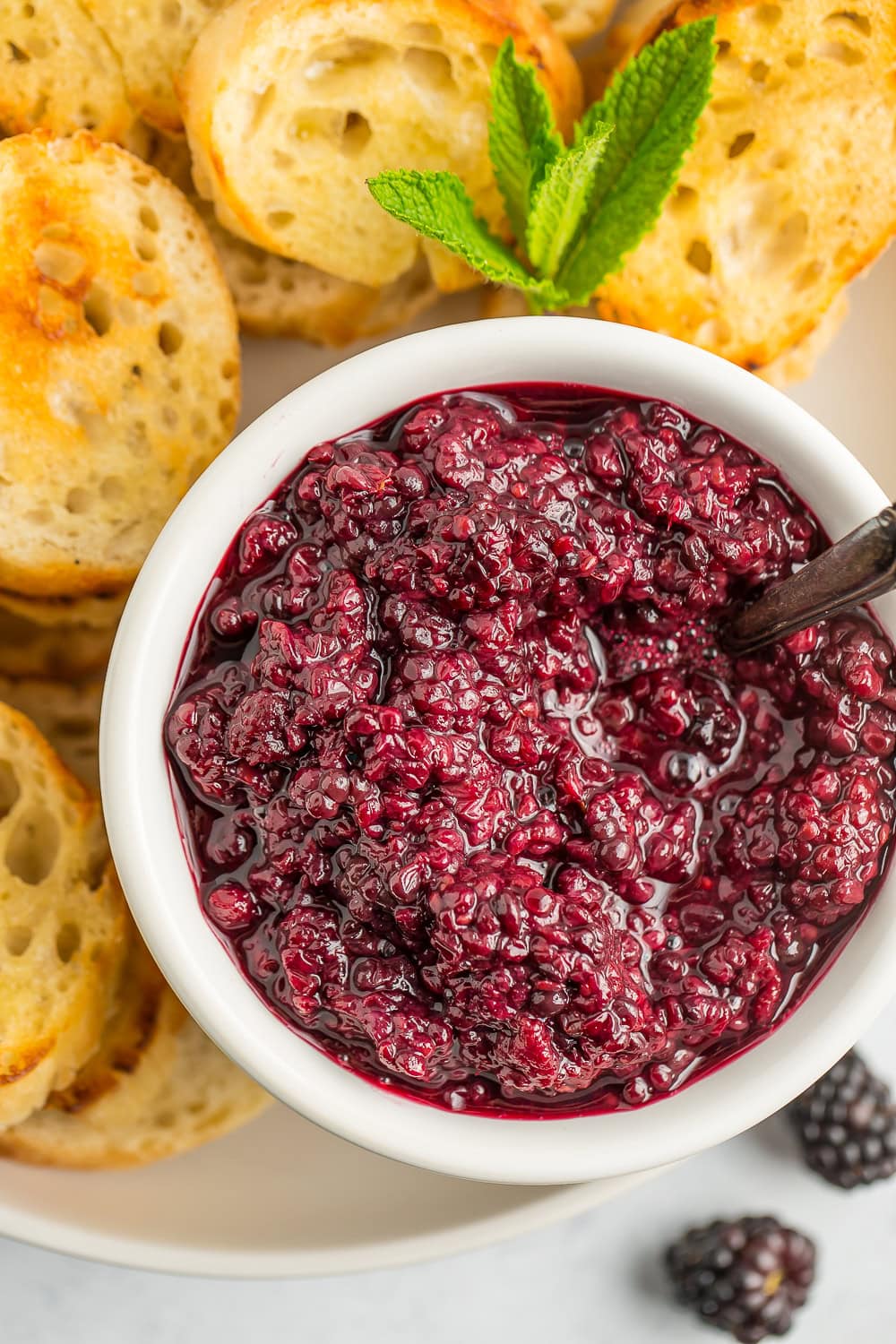 a white bowl of berry sauce.