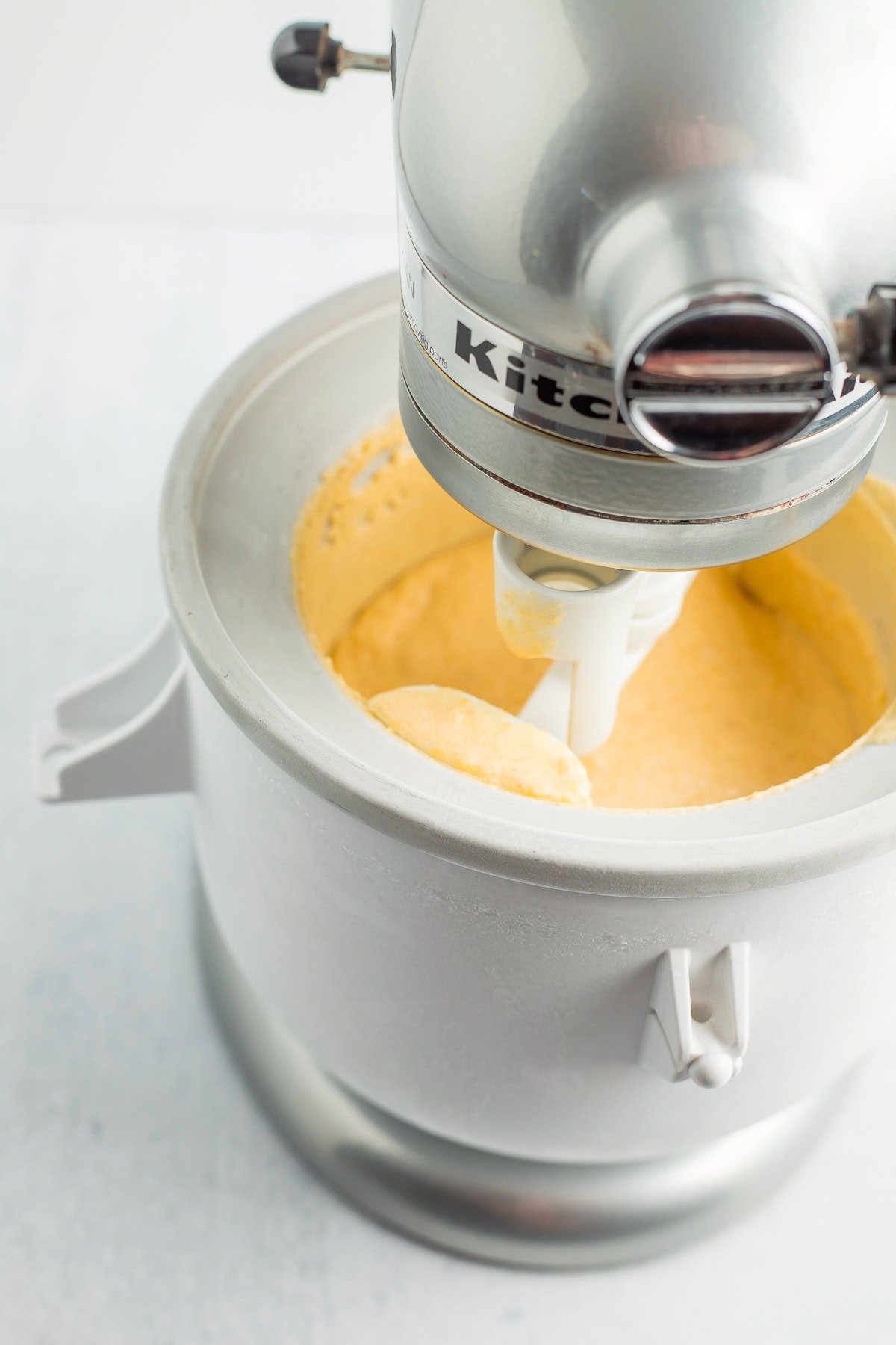 a kitchen aid mixer and ice cream bowl.