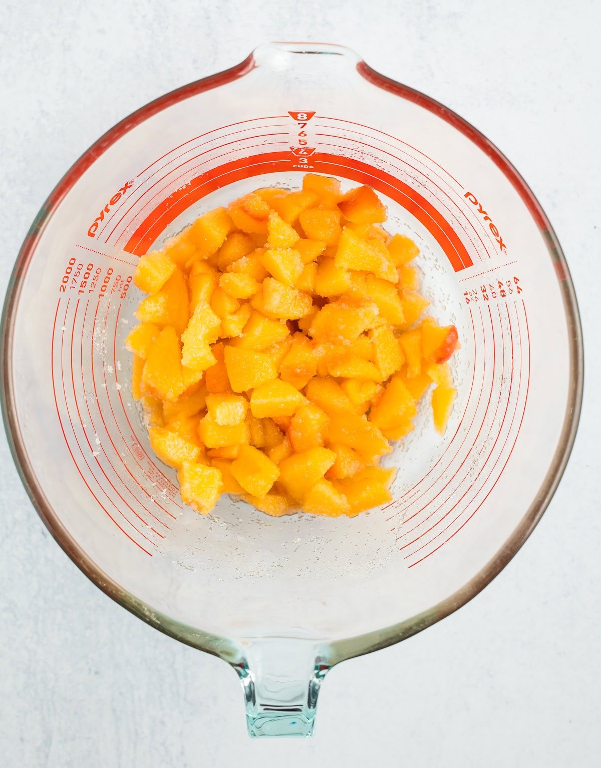 chopped peaches in a glass bowl.