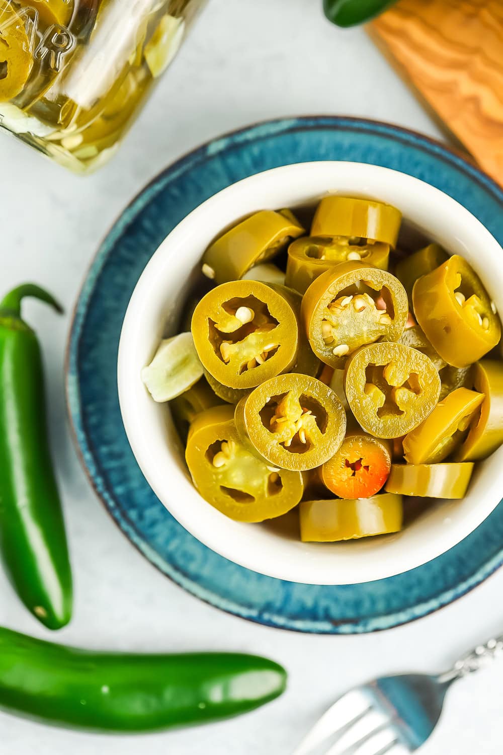 sliced pickled jalapeños in a white bowl.
