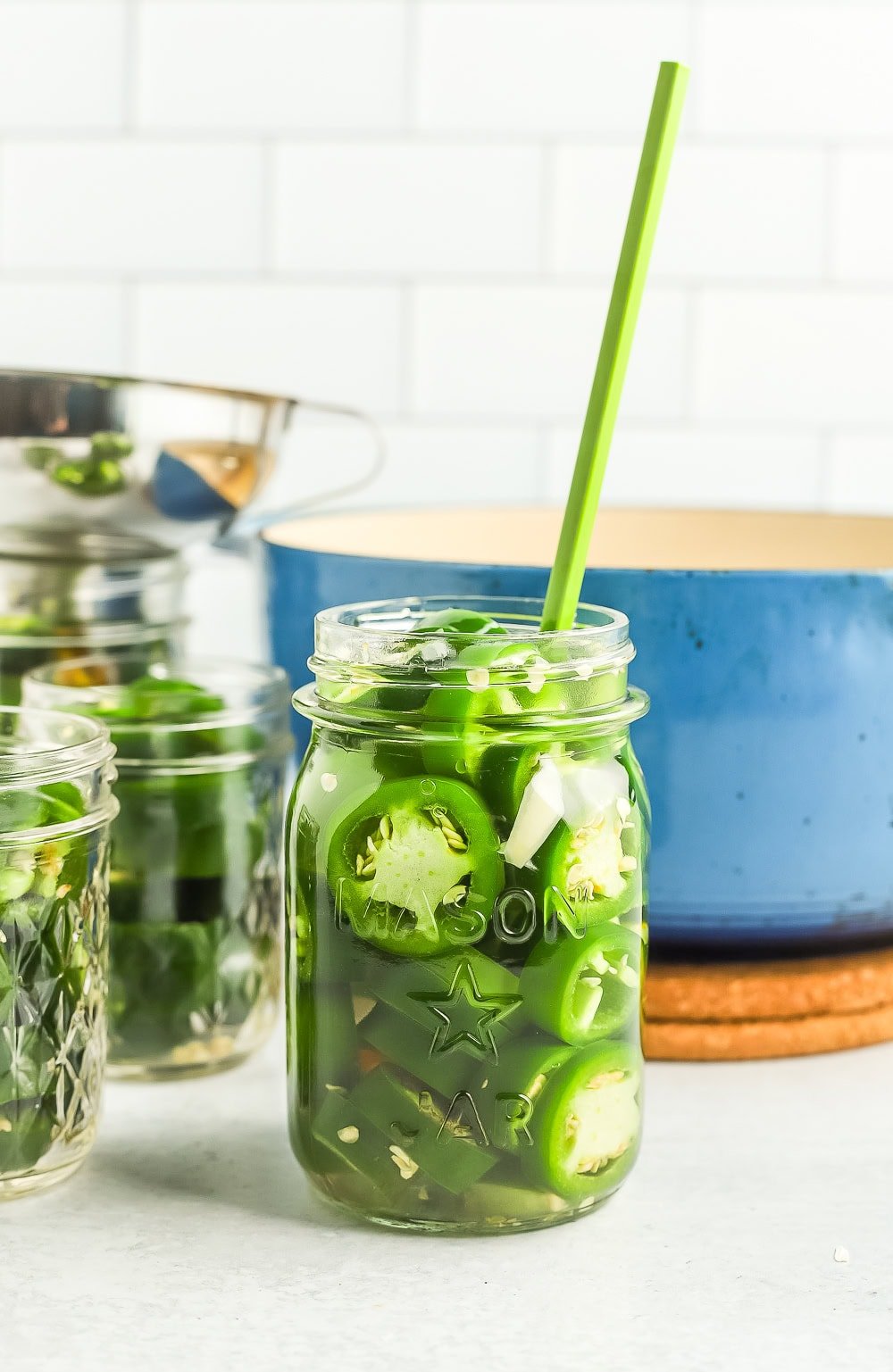 a green chopstick in a canning jar.