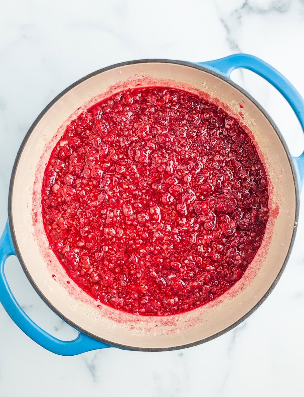 raspberry jam in a blue Dutch oven.