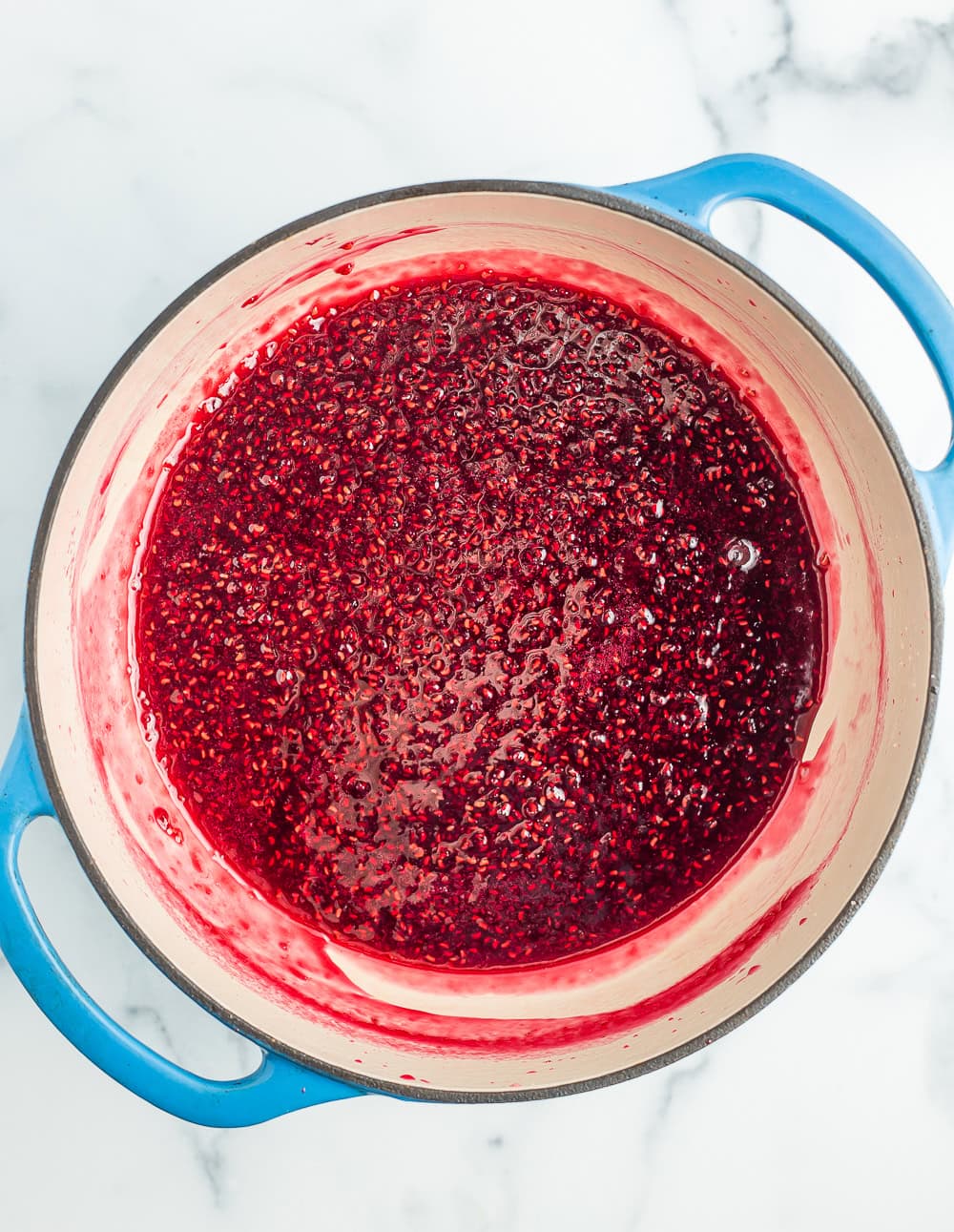 raspberry jam in a blue Dutch oven.