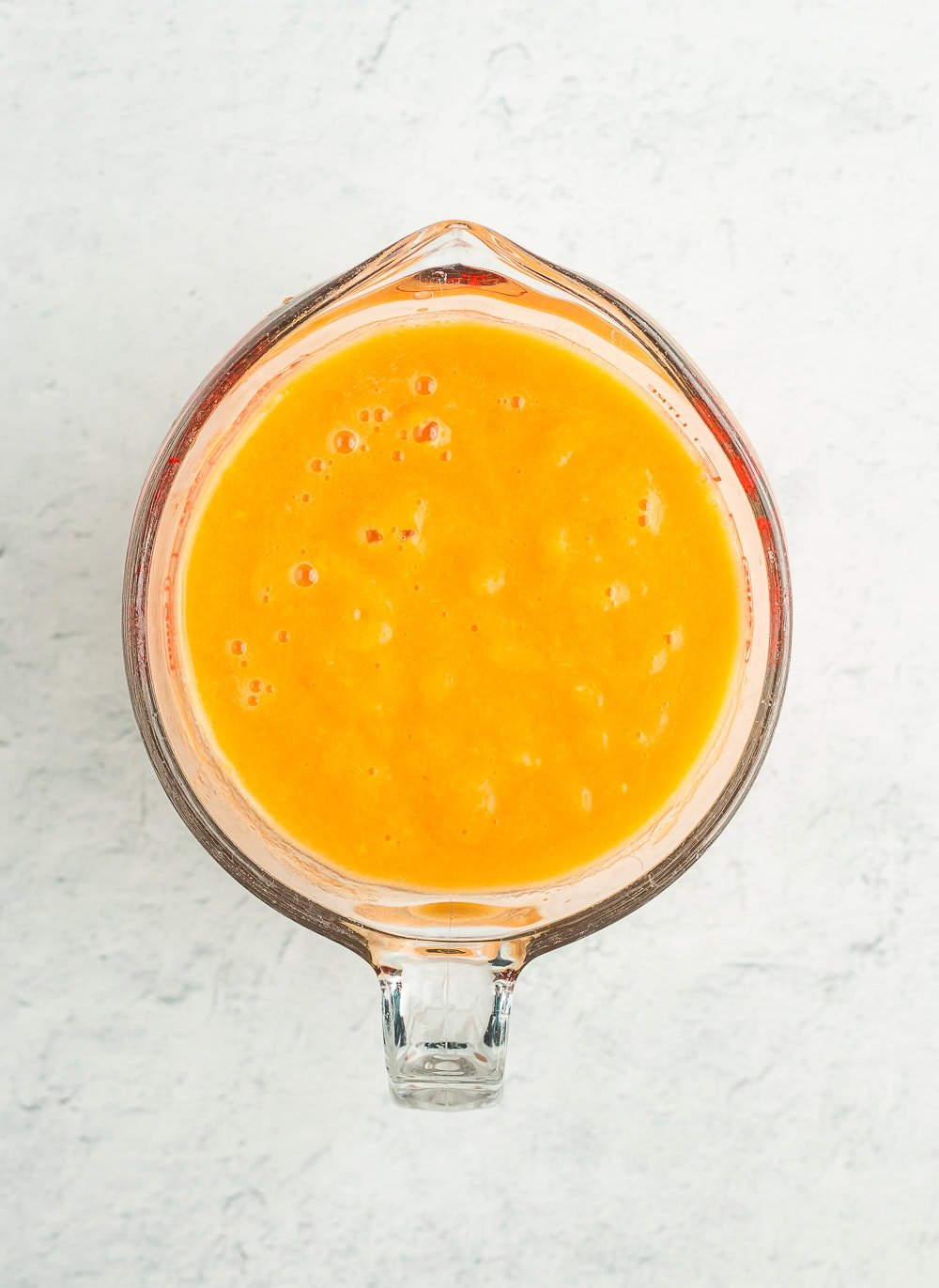 pureed fruit in a measuring cup.