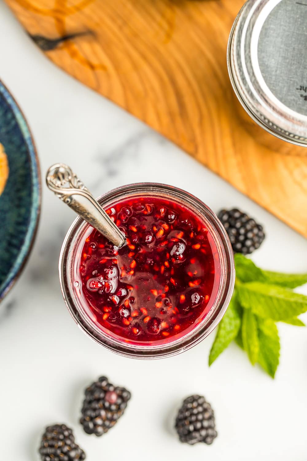an overhead photo of a jar of blackberry preserves.