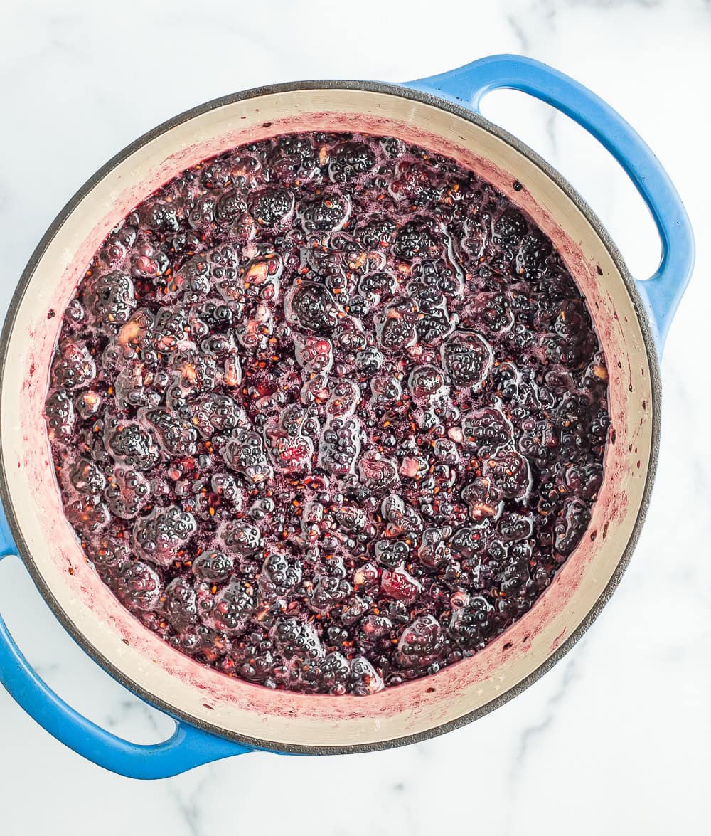 softened berries in a blue Dutch oven.