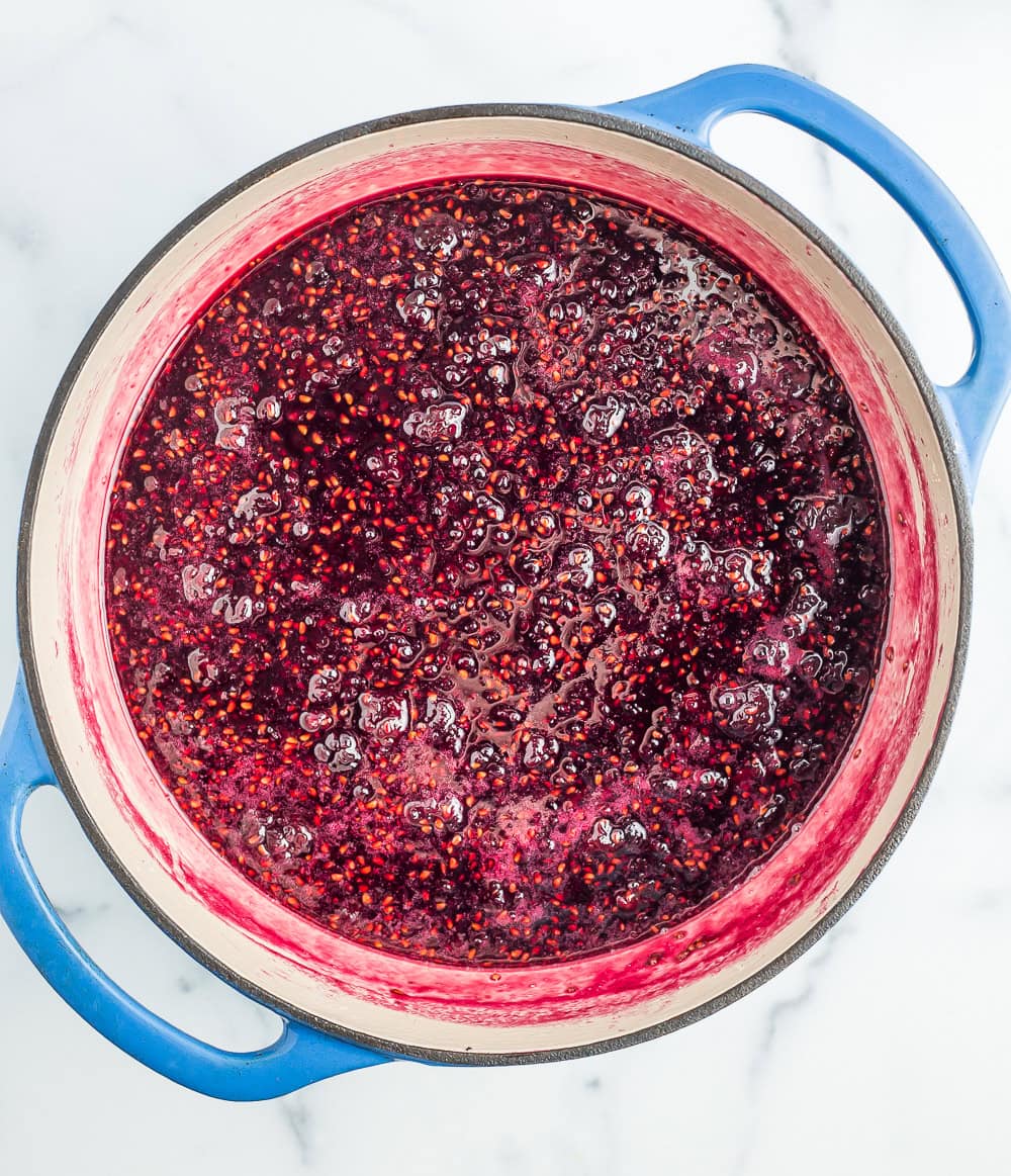 berry sauce in a blue Dutch oven.