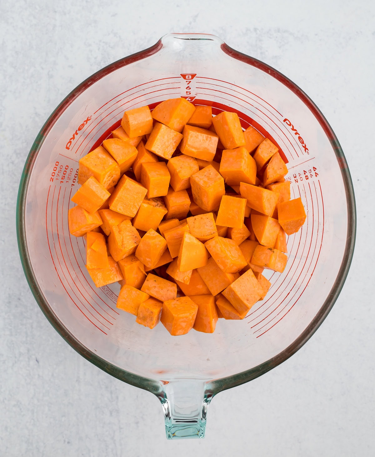 a glass bowl of cubed root veggies.