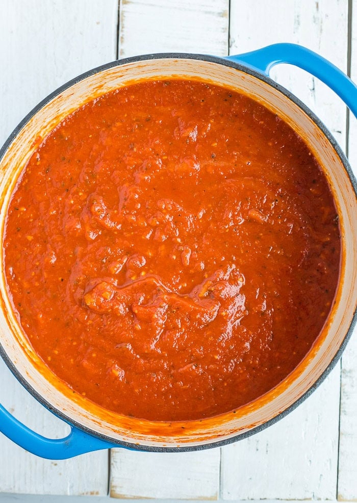 spaghetti sauce in a blue Dutch oven.