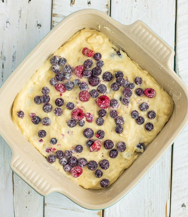 unbaked berry cake in a baking dish.