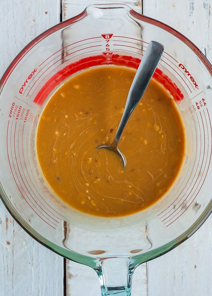 melted peanut butter and coconut oil in a glass measuring cup.
