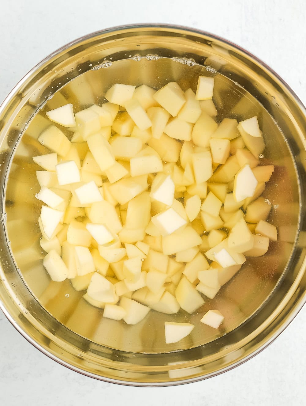 chopped pears in a bowl of water.