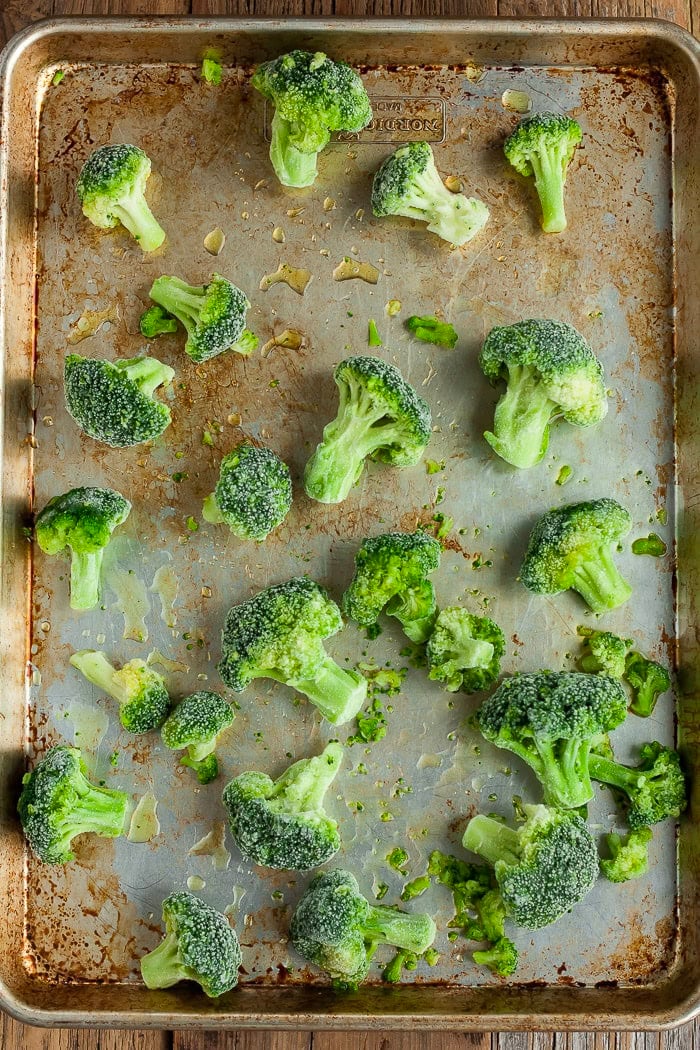 Broccoli florets on a baking pan.