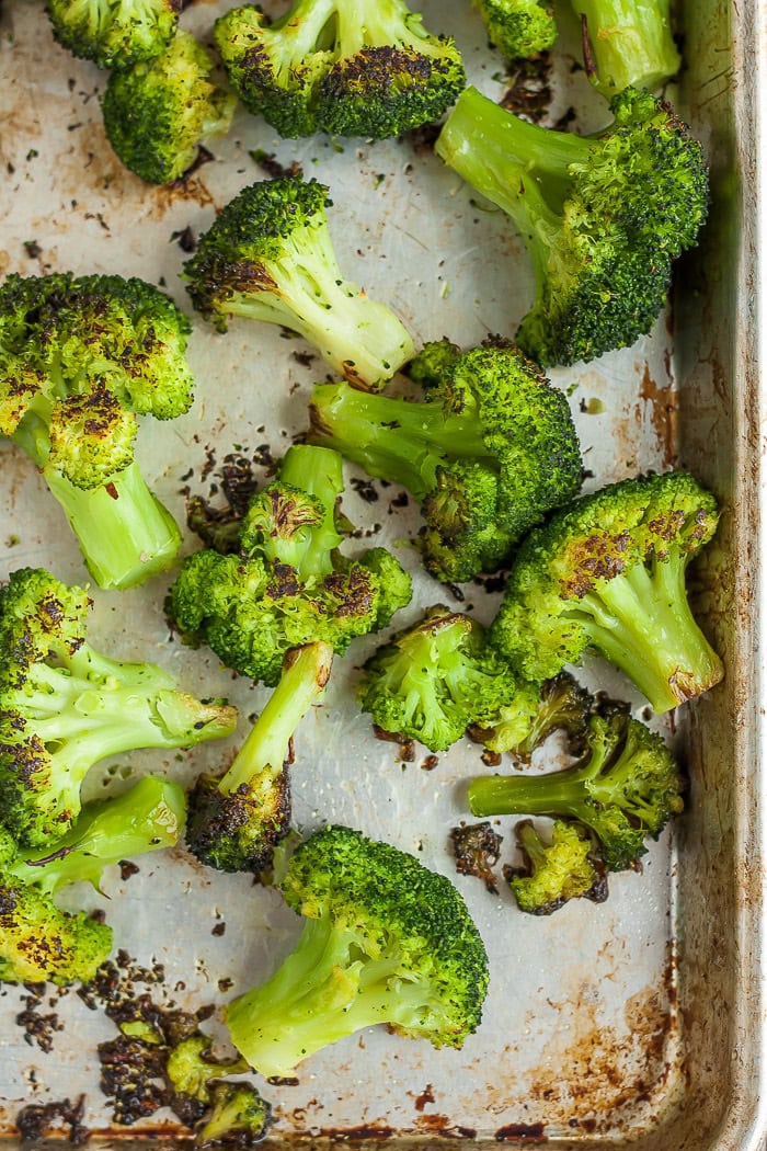 roasted broccoli florets on a baking pan.