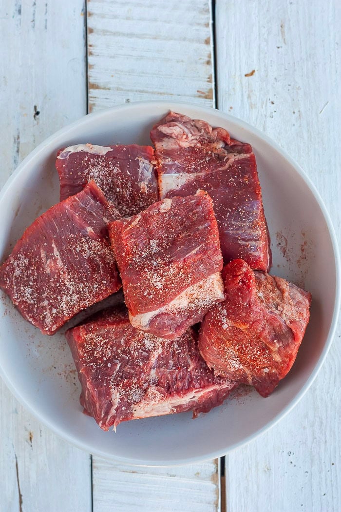 multiple chunks of salted beef in a white bowl.