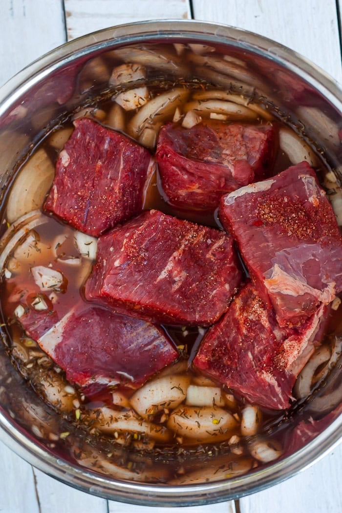 chunks of beef in a pressure cooker.