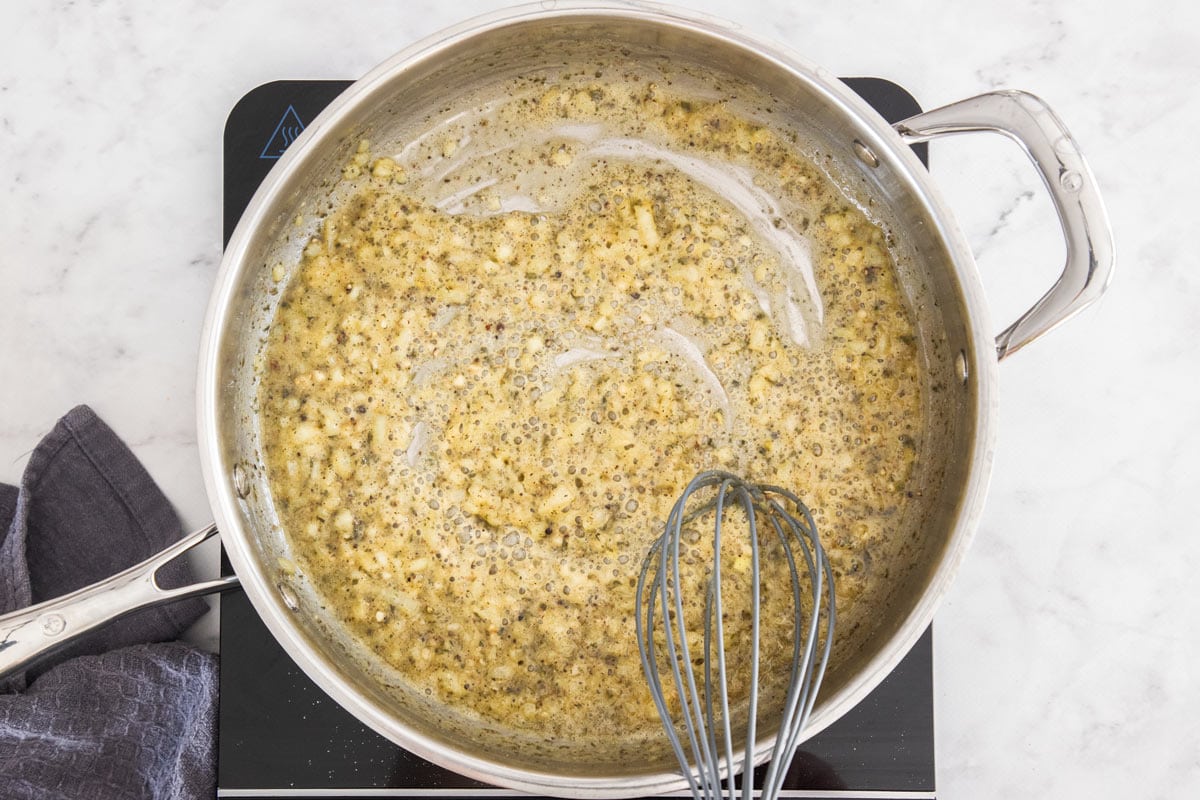 onions, herbs, and butter in a skillet with a whisk.