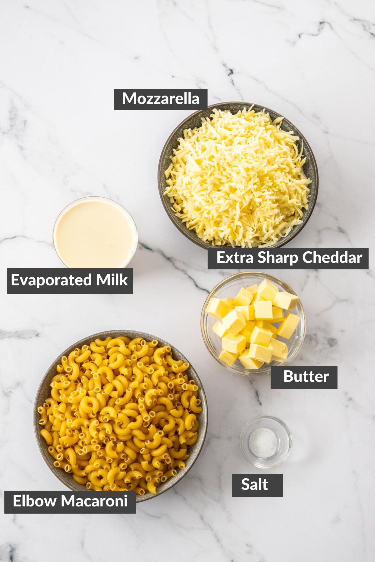 bowls of ingredients on a marbled board.