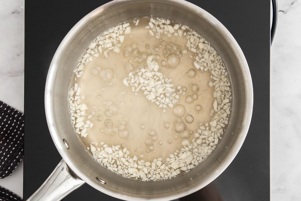 chopped garlic and liquid in a saucepan.