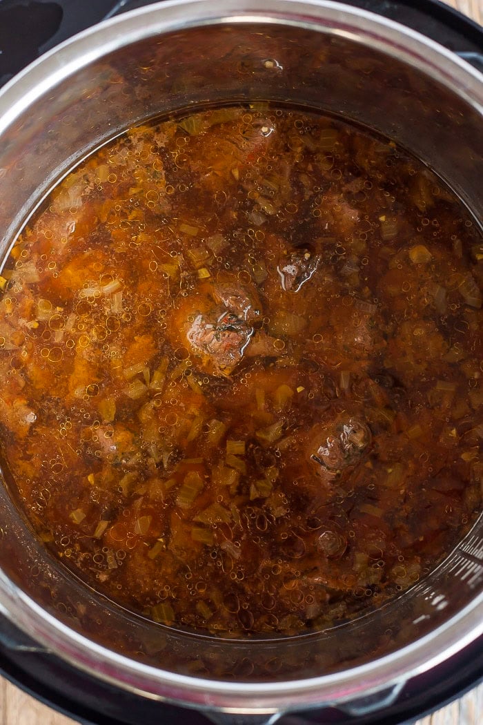 broth and other ingredients in a pressure cooker.