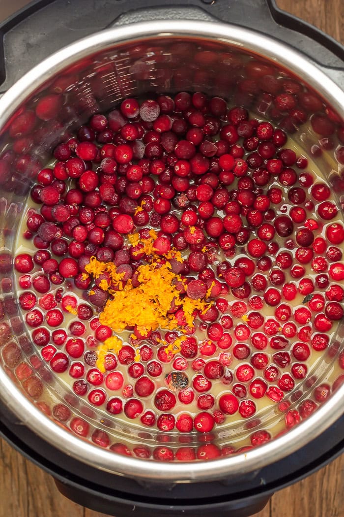 orange zest, orange juice, and whole cranberries in a pressure cooker.