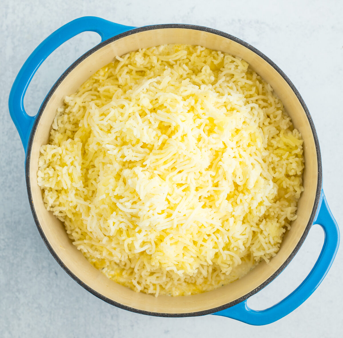 riced potatoes in a blue Dutch oven.