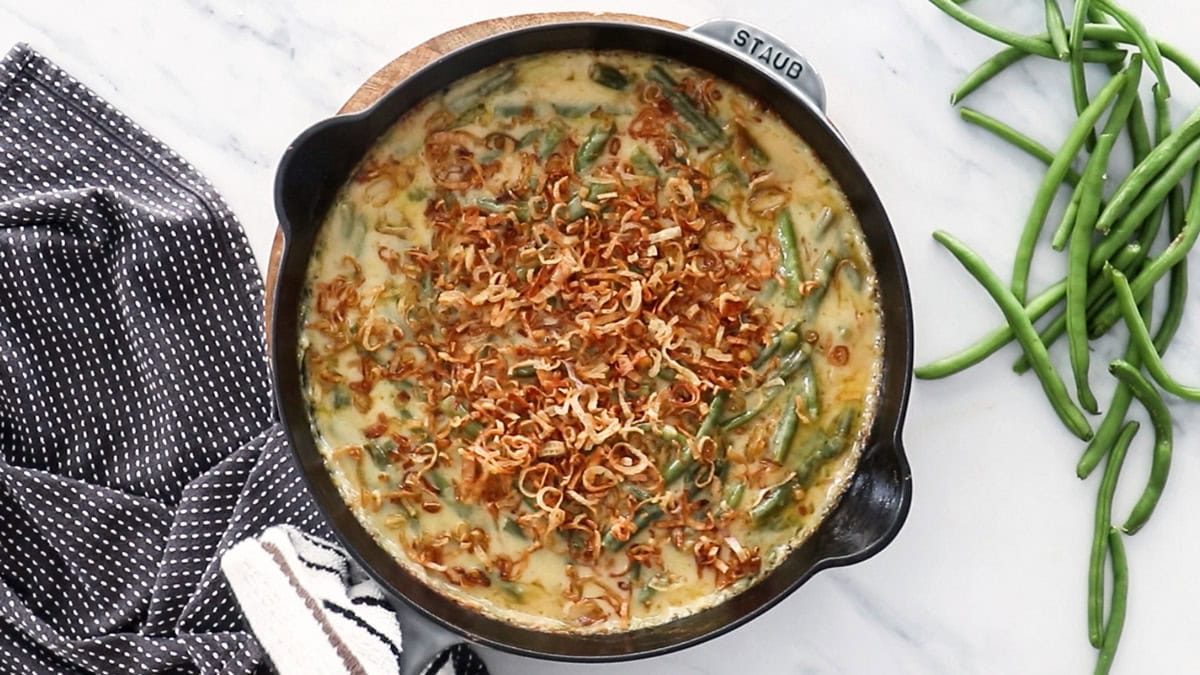 fried shallots on top of a casserole in a skillet.