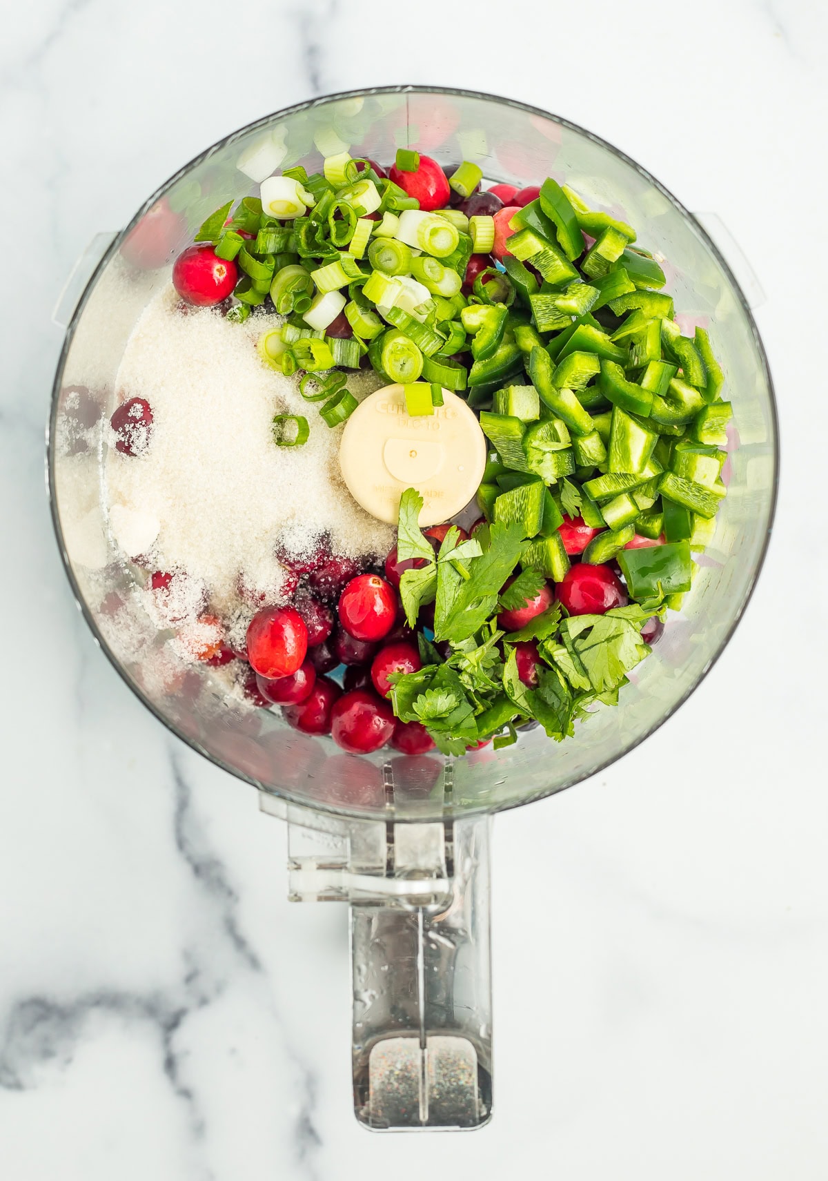 chopped jalapeños and other ingredients in a food processor.