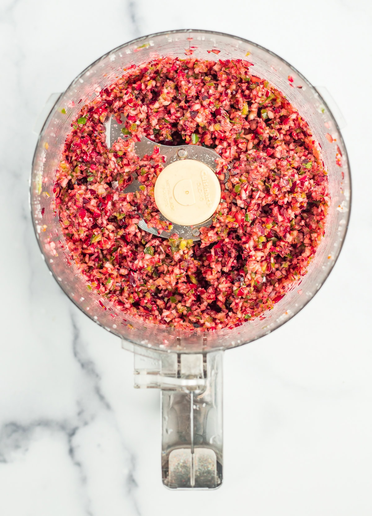 chopped cranberries and peppers in a food processor.