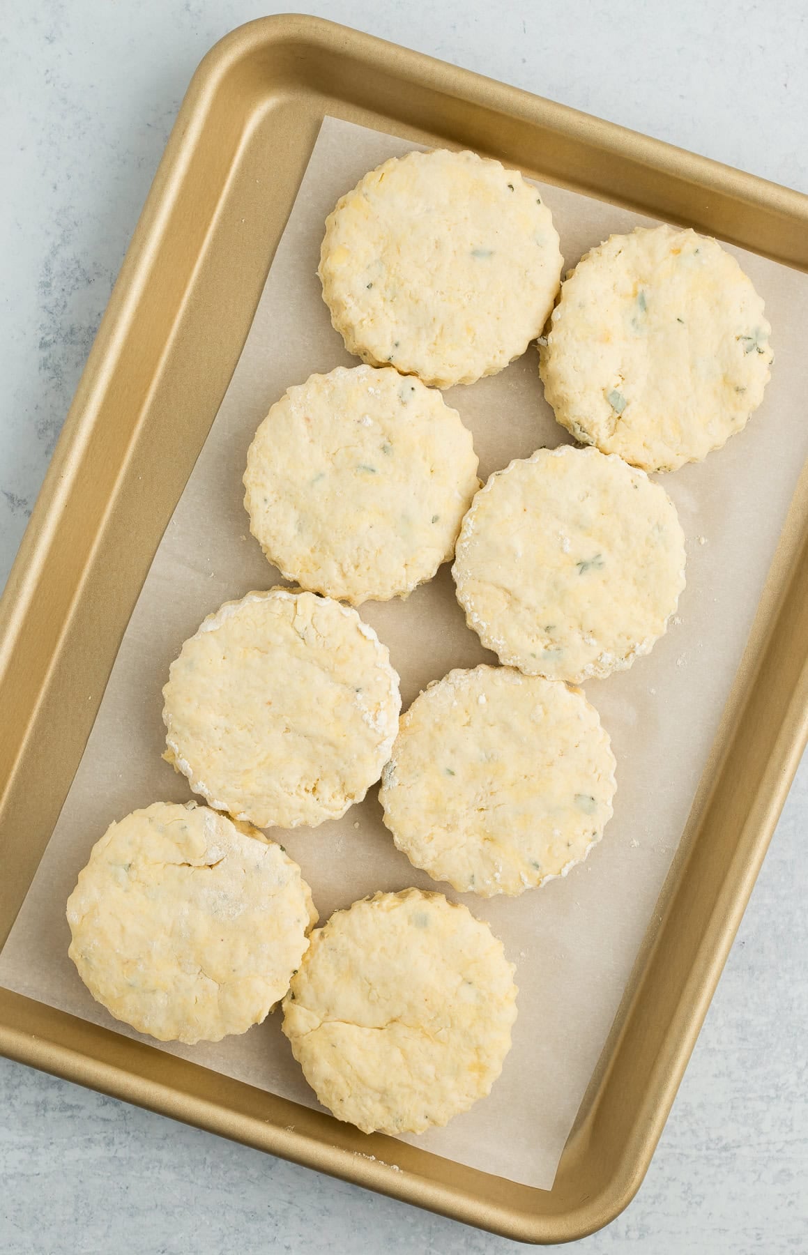 unbaked biscuits on a baking sheet.