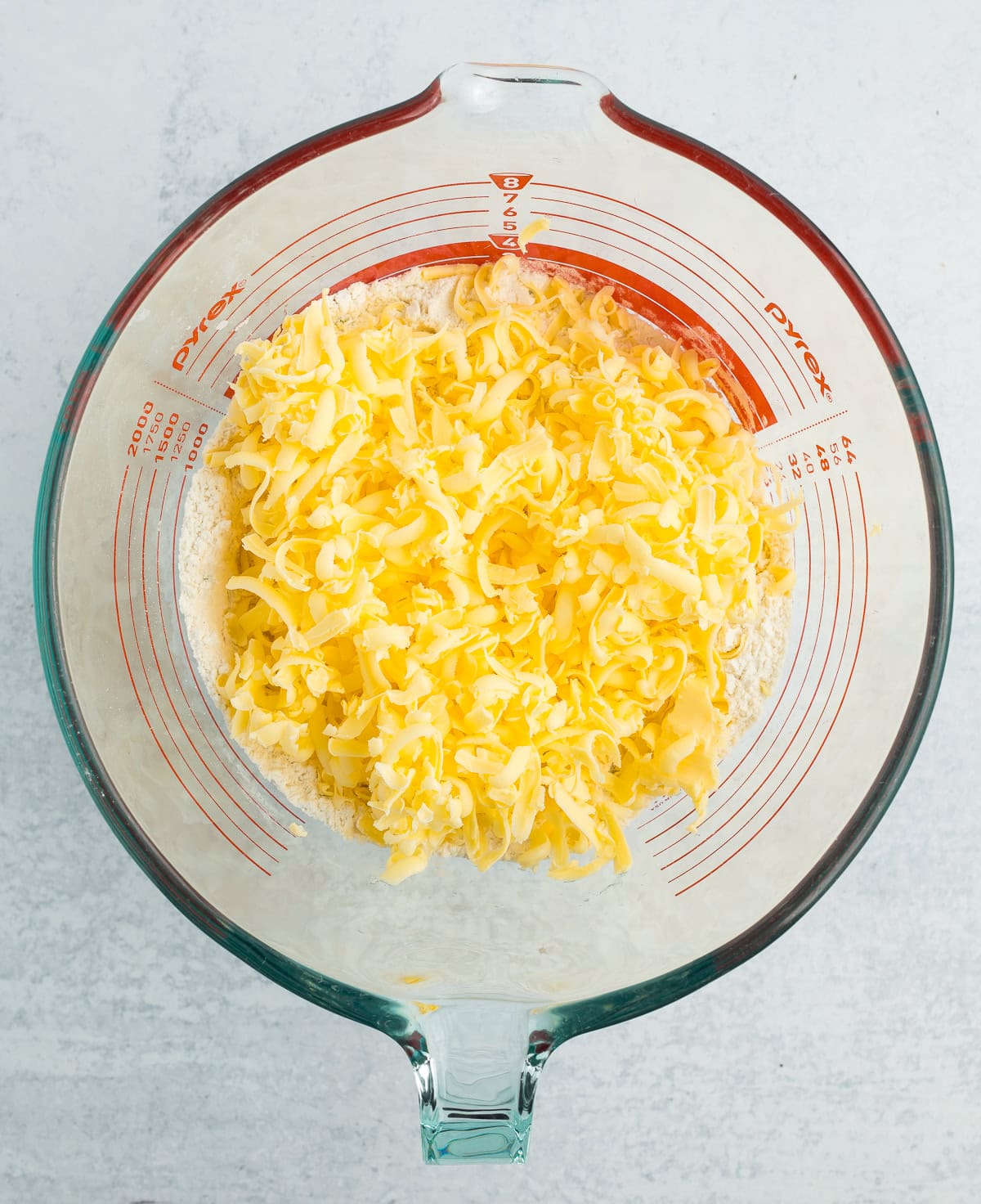 grated butter in a glass bowl.