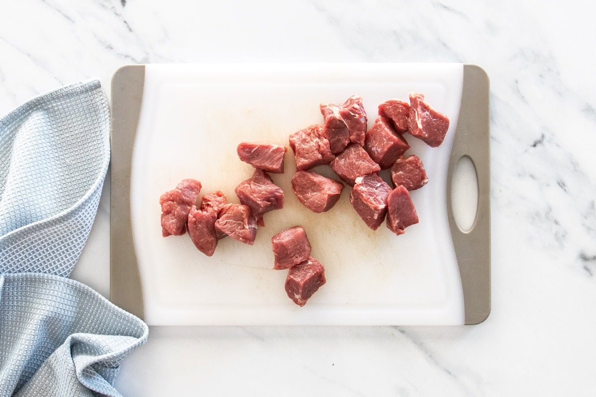 sliced cubed sirloin on a cutting board.