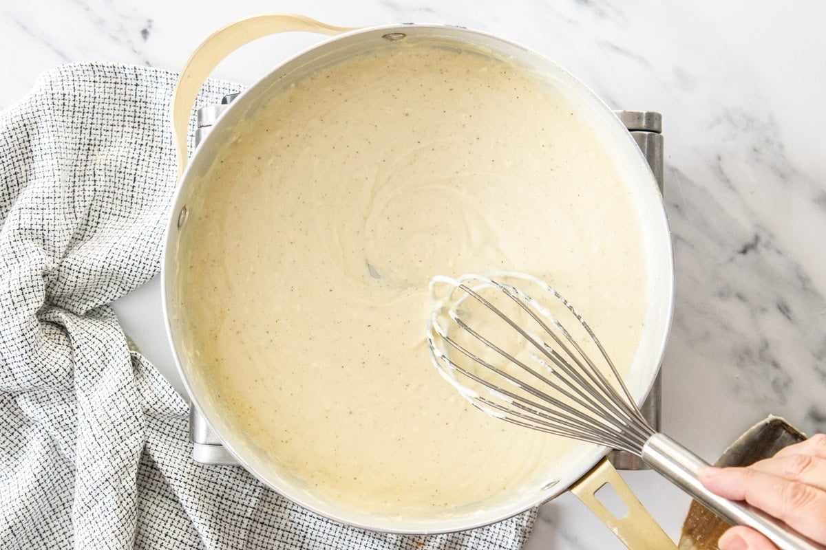 a cream sauce in a skillet.