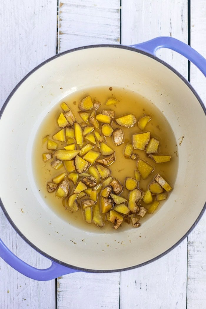 chopped ginger in a blue Dutch oven.